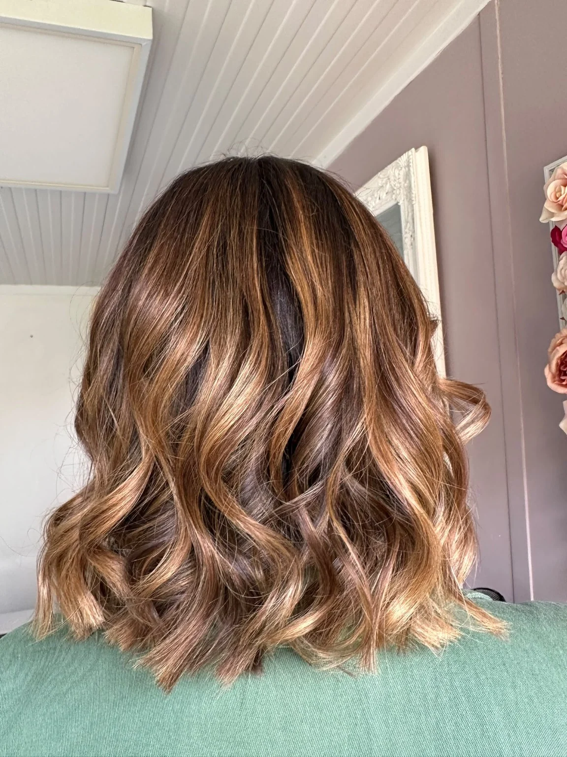 Warm copper and brunette shoulder-length hair styled in waves